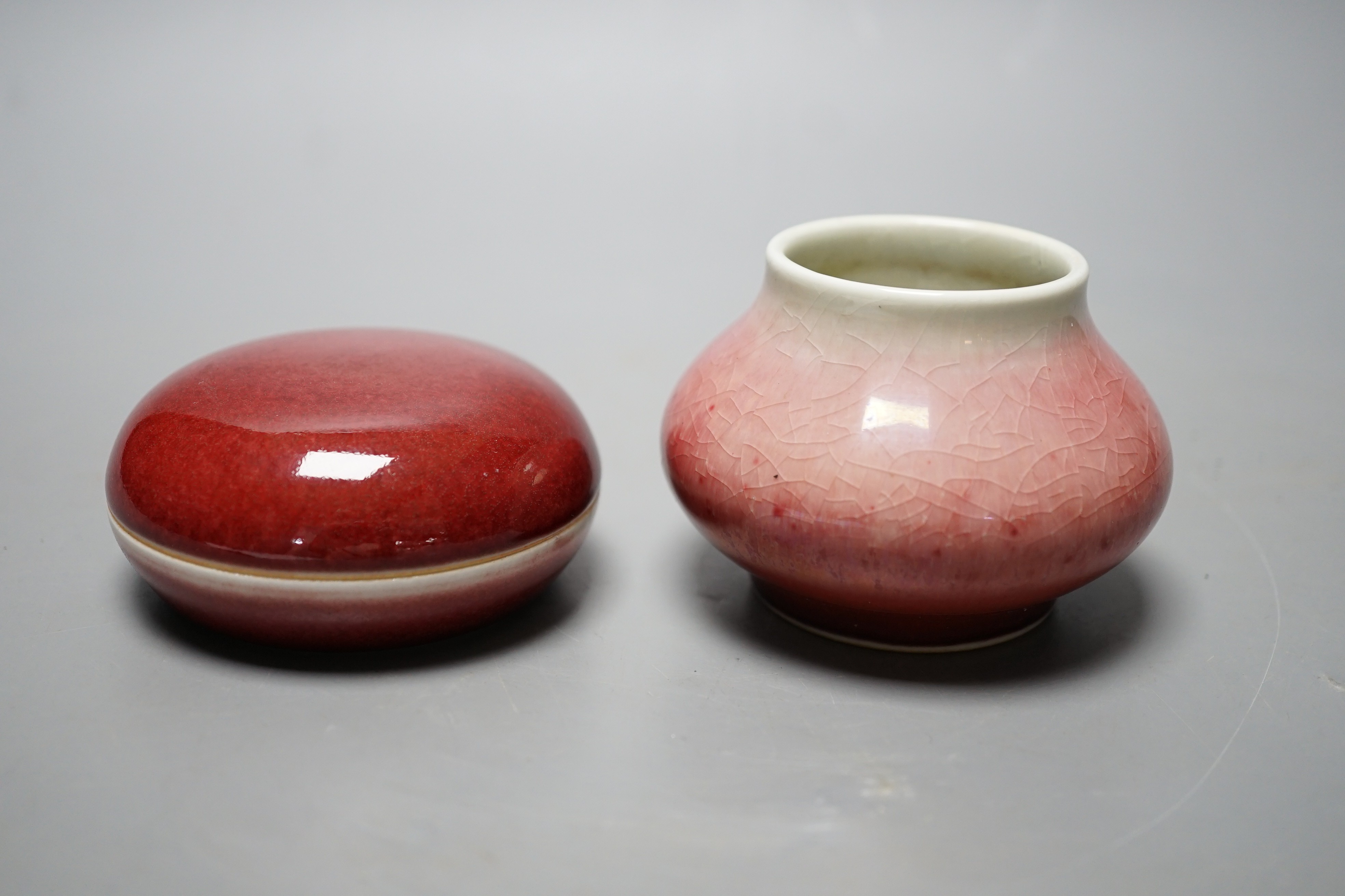 A Chinese sang de boeuf glazed seal paste box and a small pot (2) box 7.5cm diameter